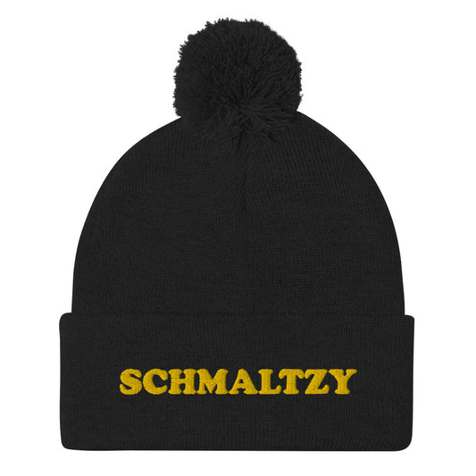 Cute, warm and cozy, schmaltzy beanie. Black or navy with yellow schmaltzy embroidery and a pom pom on top. This classic beanie and unusual schmaltzy design is a funky hat that's stylish, warm and comfortable. Shop weird hats, foodie beanies, funky crop tops, shirts for garlic lovers and more. All original designs by us.