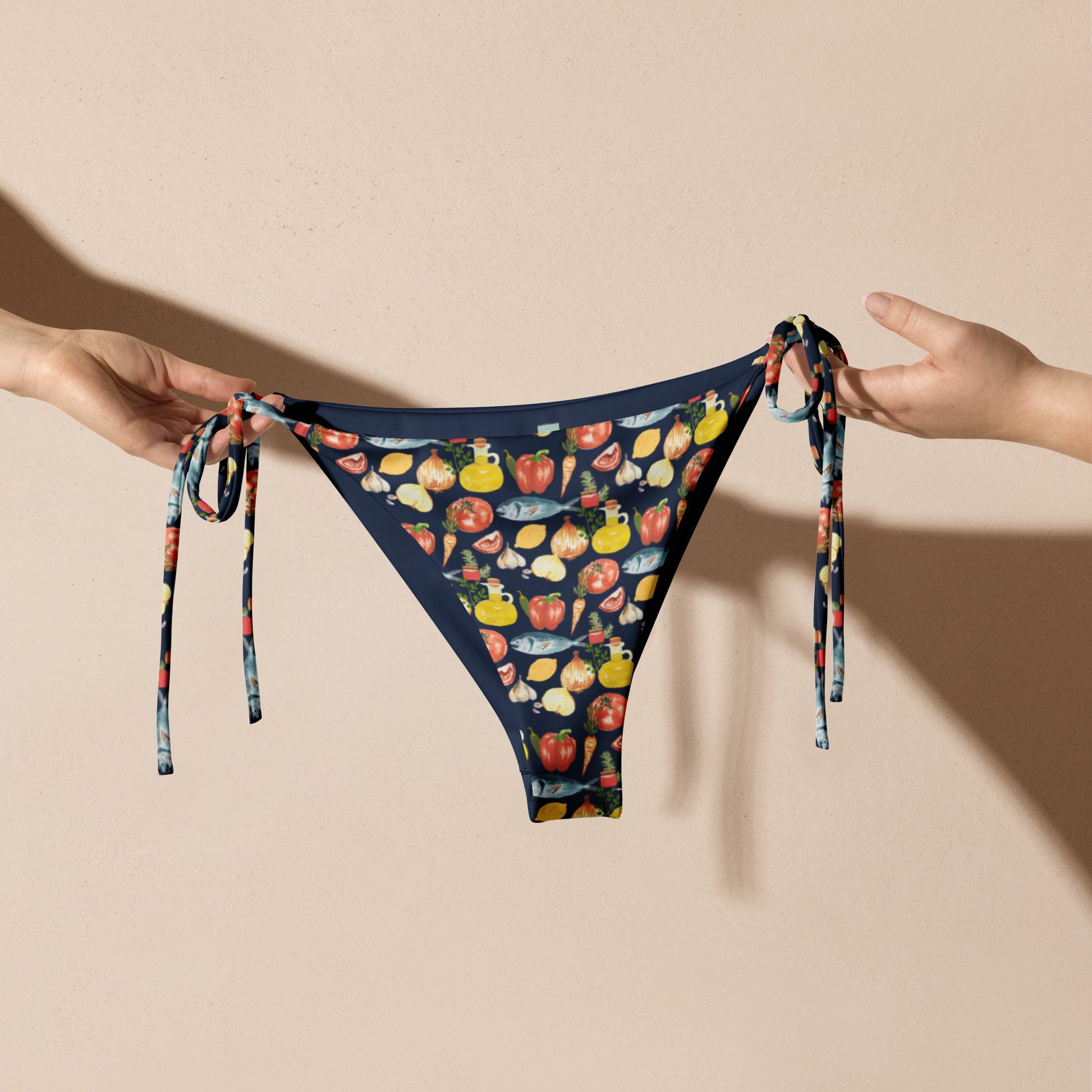 Classic bikini bottom with quirky and colorful foodie patter featuring veggies, olive oil and fish