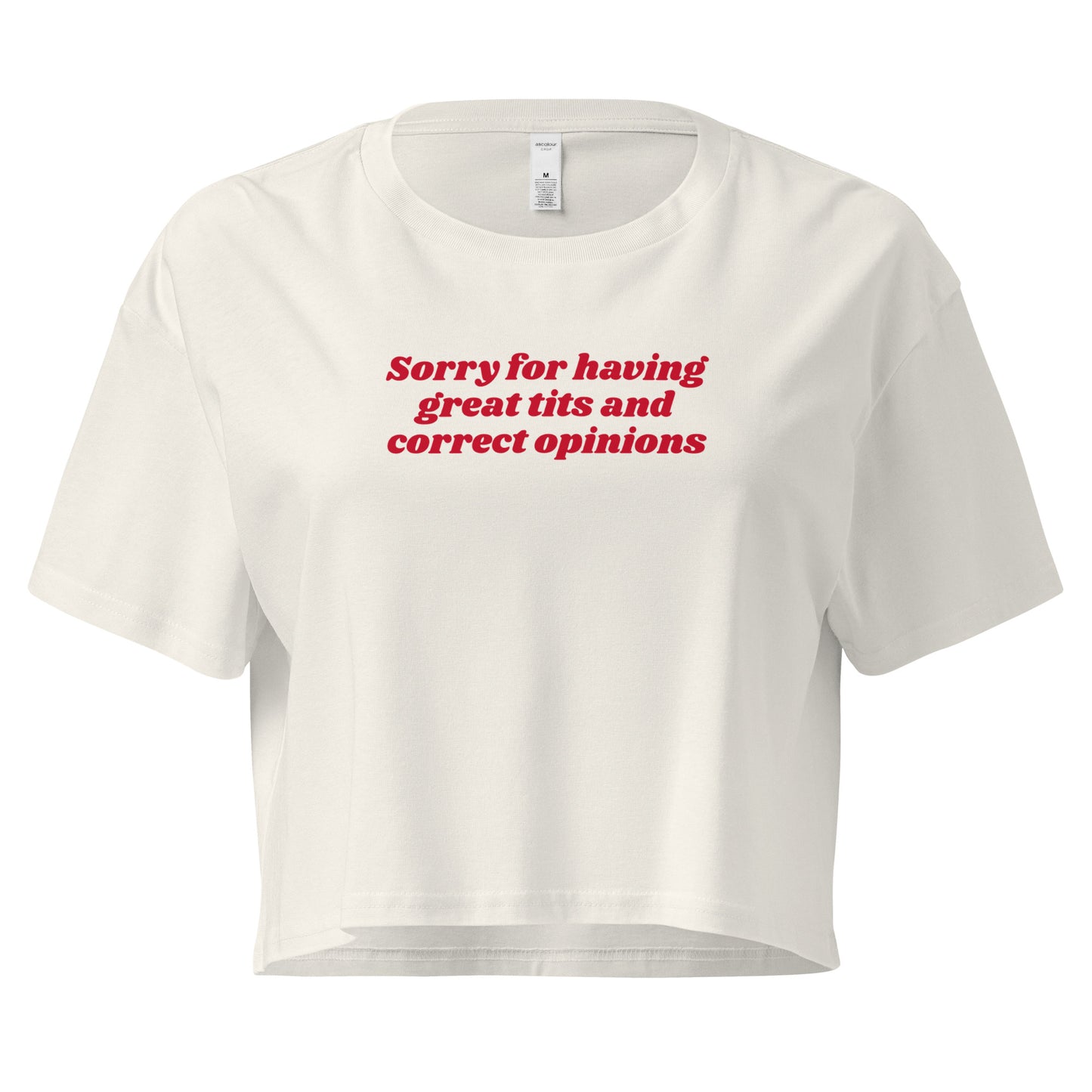 White crop t-shirt with the text 'Sorry for having great tits and correct opinions' printed in red on the front.