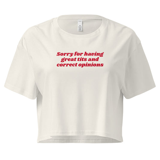 White crop t-shirt with the text 'Sorry for having great tits and correct opinions' printed in red on the front.