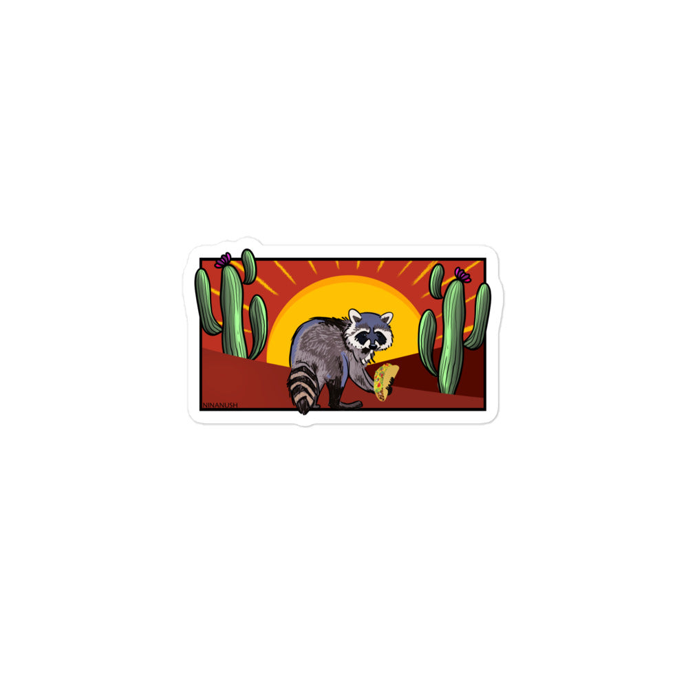 Naughty raccoon with taco sticker from Nina's Funky Shop by ninanush - The Desert Raccoon Vinyl Sticker! Crafted for raccoon enthusiasts, this unique sticker captures the charm of a naughty raccoon enjoying a taco. It's an original hand drawn design by Nina and it's made just for you. This funky raccoon sticker is the perfect for your sticker collection or gift for a raccoon lover.