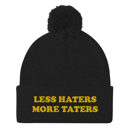 Black Less Haters More Taters Hat from Nina's Funky Shop - Lover potatoes? Looking for a funny gift? This warm and cozy, embroidered beanie is just what you need. It's a classic pom pom beanie with "less haters more taters", expertly embroidered on the front. The perfect funny beanie for potato enthusiasts and foodies of all kinds. Celebrate your favorite foods in our funky foodie apparel.