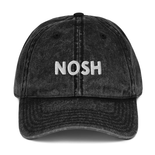 Black nosh dad hat - A nosh hat with a simple text embroidery, vintage-style faded material and it comes in a variety of colors. It's a funny dad hat for foodies or a gift for noshers and food enthusiasts. Nosh on your favorite foods in this yiddish word hat. It's a perfect hat for everyday wear and a unique dad hat for snack lovers.